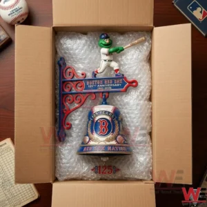 The same decorative anniversary collectible is now nestled in bubble wrap within an open cardboard shipping box with a wooden table surface visible outside!
