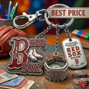 A three part detailed silver keychain is shown with three separate charms! The charms show a large Red Sox logo with the text 125 a detailed replica of Fenway Park and a dog tag that mentions the 125th anniversary celebration! The keychain is surrounded by other baseball themed items on a wooden table!