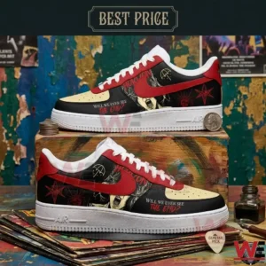 Custom black and red sneakers featuring band graphics and text resting on a wooden display!