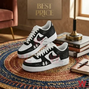 Custom black and white sneakers with artist text and signatures displayed on a circular woven rug next to books and a notebook!