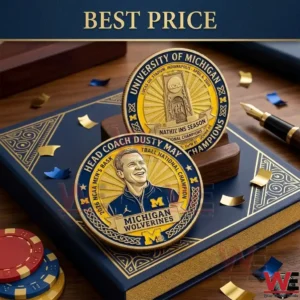 Two commemorative gold coins for the Michigan Wolverines national championship on a blue book!
