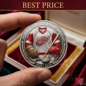 A hand displays a silver anniversary coin for the Detroit Red Wings hockey team with detailed sports equipment imagery!