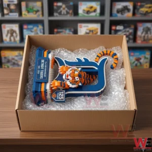 An open cardboard shipping box filled with bubble wrap holding a completed brick model of a tiger and a blue letter D!