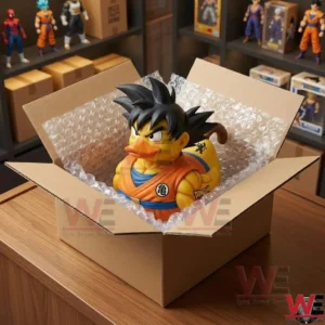 A collectible rubber duck figure sitting in an open cardboard box lined with bubble wrap on a desk!