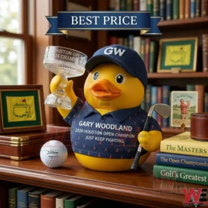 A yellow rubber duck dressed in golf attire holding a trophy and club on a library shelf next to a golf ball!