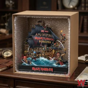 A detailed heavy metal themed pirate ship diorama resting inside an open cardboard box lined with bubble wrap on a desk!