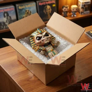 Top view of a vinyl mummy toy being packed for shipping inside a cardboard box with bubble wrap!