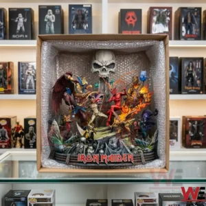 A photo looking into an open cardboard shipping box. The complex and detailed multi character Iron Maiden battle diorama statue from image 2 is visible, packed securely inside layers of bubble wrap. The box is on a glass shelf with other retail item boxes in the background.