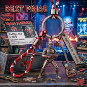 A heavy metal band keychain with a braided cord a cyborg figure a guitar charm and a metal tag on a wooden surface!