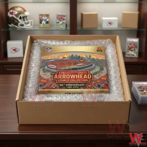 An open cardboard box lined with bubble wrap containing a gold and red football team anniversary collectible box!