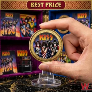 Close up of a hand holding a gold commemorative KISS coin with band members depicted on the front!