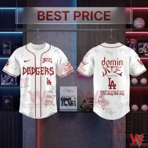 LA Dodgers x Stray Kids Merch Dominate World Tour New Jersey 10 White baseball jerseys with red Dodgers and Stray Kids branding hanging in a clean retail display area!