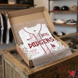 LA Dodgers x Stray Kids Merch Dominate World Tour New Jersey 11 A white Dodgers baseball jersey packed in a cardboard box with protective foam on a wooden counter!