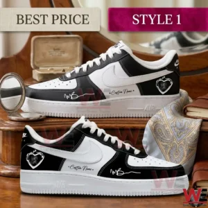 Custom black and white sneakers with heart logos and signatures displayed on a wooden table with vintage accessories.