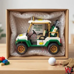 A side view of the Masters brick golf cart model securely packed in bubble wrap inside a cardboard box on a wooden desk.