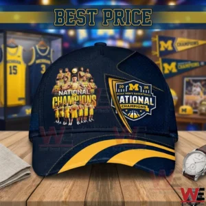Navy blue Michigan basketball championship cap with yellow details and player graphics displayed on a wooden table!