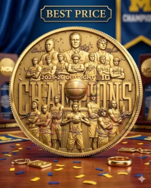The back of a gold championship coin featuring basketball players and coach with engraved signatures and bold text on a wooden surface.