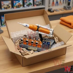 NASA Artemis II Crew 2026 Launch Diorama Brick Set 3 An open shipping box containing a plastic brick space mission model cushioned with protective wrap and paper!