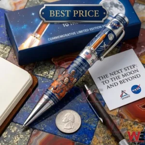 Commemorative NASA pen for the Artemis II mission resting on a stone tabletop next to a silver coin and mission gift box!
