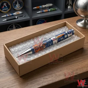 Packaging of a NASA Artemis mission pen inside a cardboard box on a wooden office desk!