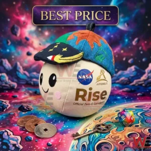 NASA Artemis II Rise Zero G Mascot Plush 4 A cute moon shaped plush toy with a world map hat displayed among space exploration themed trinkets!