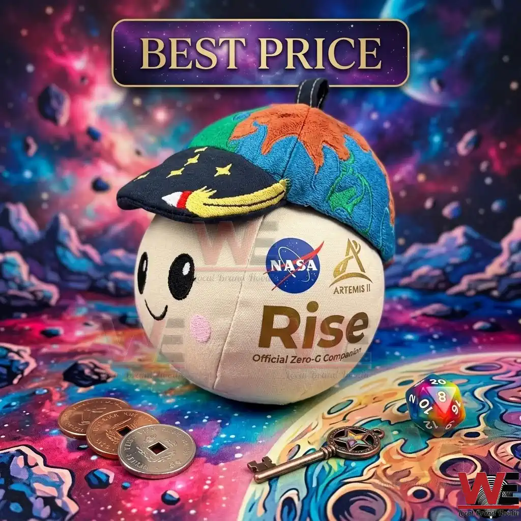 NASA Artemis II Rise Zero G Mascot Plush 2 A cute moon shaped plush toy with a world map hat displayed among space exploration themed trinkets!