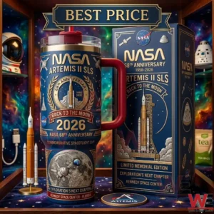 A blue and gold travel mug with a red handle featuring NASA Artemis II mission graphics placed next to its decorative box on a star patterned surface.