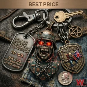A close up shot of an Iron Maiden fiftieth anniversary keychain with various gothic metal charms displayed on a leather and denim background!