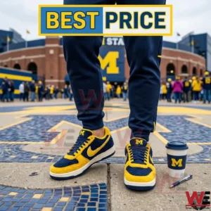 Yellow and navy blue fuzzy sneakers worn by a person standing on a university logo with a stadium in the background!
