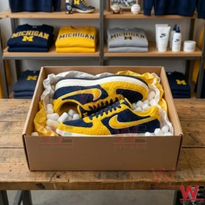 Michigan Wolverines sneakers packed with foam peanuts inside a cardboard box on a wooden table!