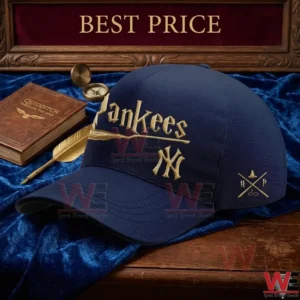 Navy blue Yankees cap with gold Harry Potter logos sitting on blue velvet next to a Quidditch book.