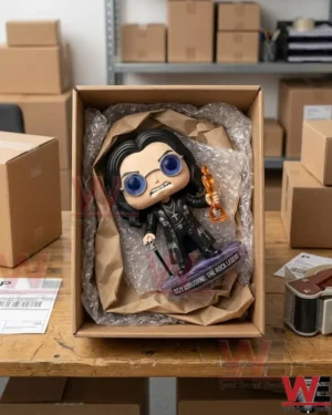 A toy figure packed inside a cardboard box with protective bubble wrap on a wooden table.
