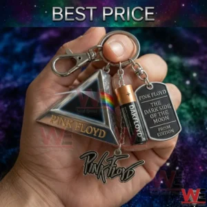 A detailed close up of a Pink Floyd themed keychain with various charms including a prism and a dog tag held in a hand!