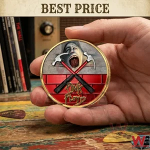 A person holding a gold and red Pink Floyd commemorative coin featuring the Wall album artwork!