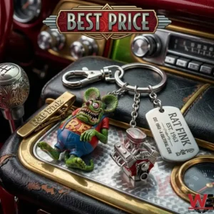 Rat Fink themed metal keychain with an engine charm on a car dashboard!