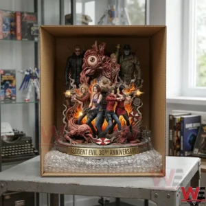 An open cardboard box contains the large detailed multi figure Resident Evil statue celebrating its thirtieth anniversary surrounded by bubble wrap cushioning on a metal table in a room with a window.