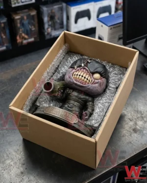 Resident Evil Nemesis 30th Anniversary Pop Figure 3 An open cardboard shipping box with a detailed figure packed in bubble wrap on a workbench!