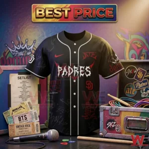 Front view of a black Stray Kids Padres jersey with red and white graphics displayed with a microphone and drumsticks in a concert setting!