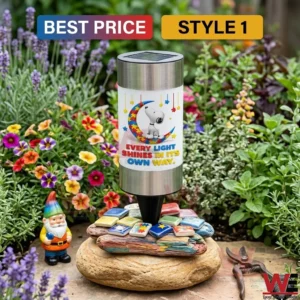 Solar garden light with a cartoon dog on a puzzle piece moon sitting on decorative rocks in a garden!