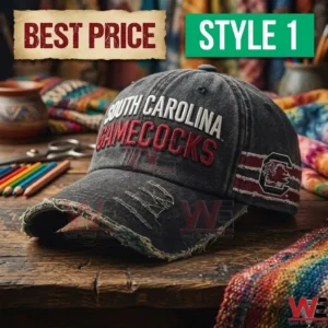 Washed dark gray South Carolina Gamecocks hat with frayed edges on a wooden table.