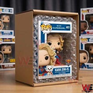 A boxed vinyl figure of Supergirl protected by bubble wrap inside a shipping carton.