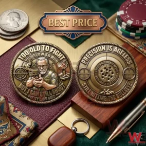 Bronze challenge coin with a shooter on the front and a target on the back displayed with office and gaming items.