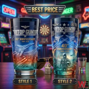 A photograph of two tall drinking glasses with Top Gun movie graphics and anniversary text placed on a bar table with aviator glasses and a lighter!