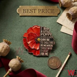 A red enamel poppy pin on a green surface!