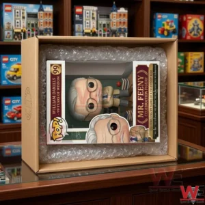 William Daniels 99th Birthday Celebration Pop Figure 3 An open cardboard shipping box showing a collectible toy box secured with bubble wrap on a glass table!