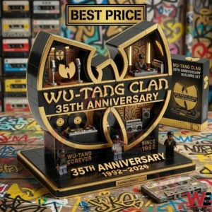 A large black and gold building block model in the shape of a famous rap group logo is shown! It has small figures and music equipment dioramas built into it! The set is displayed on a table with graffiti!