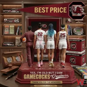 Commemorative figurine of South Carolina basketball stars on a desk with sports collectibles.