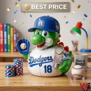 A green dinosaur toy in a Dodgers uniform holding a World Series trophy and a baseball on a desk!