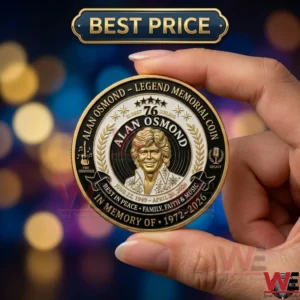 Alan Osmond Legend Memorial Coin 4 A person is holding a detailed gold commemorative coin with a portrait of Alan Osmond against a blurred lights background!