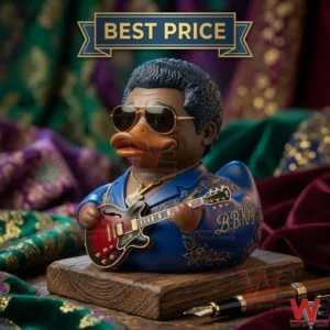 A blue duck toy dressed as a blues guitarist holding a red electric guitar on a wooden base.